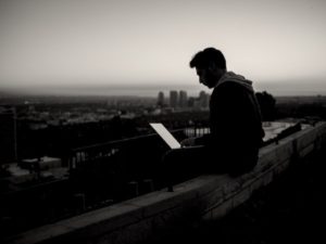 Person with laptop on roof