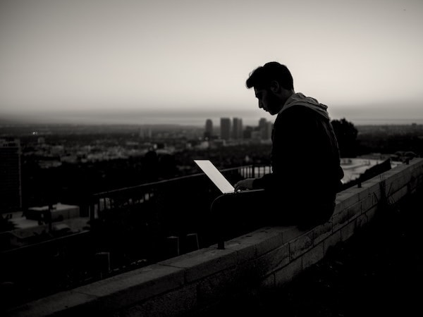 Person with laptop on roof